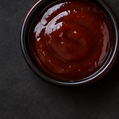 Honey BBQ sauce in a black bowl