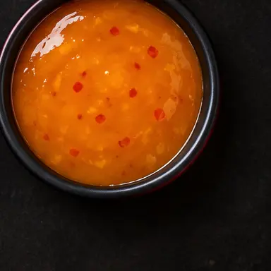 Mango Habanero signature sauce in a black bowl